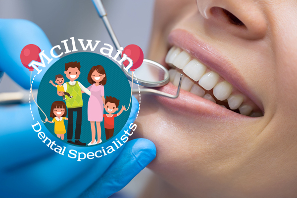 Woman smiling with dental tools next to a logo of McIlwain Dental Specialists.