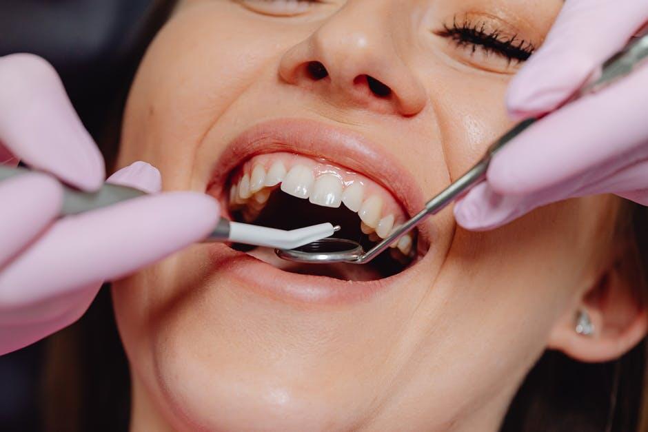 Woman at dentist getting teeth examined